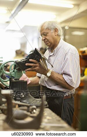 Cobbler repairing leather boot View Large Photo Image Stock Image - Cobbler repairing leather boot. Fotosearch