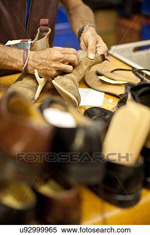 Stock Photography - Cobbler repairing leather boot. Fotosearch