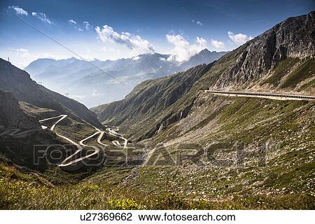 Stock Image - Distant view of old road to Gotthard Pass, Switzerland. Fotosearch