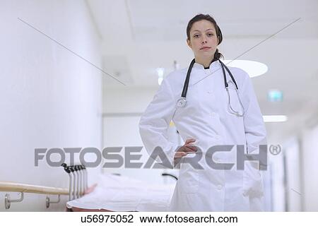 Doctor standing with hands on hip View Large Photo Image Stock Image - Doctor standing with hands on hip. Fotosearch