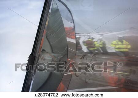 Stock Image - Emergency Response Team reflected in glass of lamp. Fotosearch