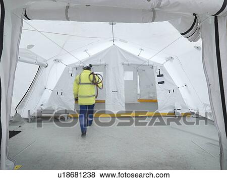 Emergency Response Team worker in control centre tent View Large Photo Image Stock Photo - Emergency Response Team worker in control centre tent. Fotosearch