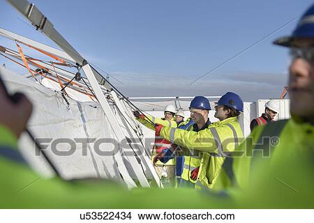 Emergency Response Team workers erecting tent control centre View Large Photo Image Picture - Emergency Response Team workers erecting tent control centre. Fotosearch