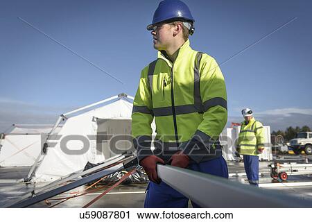 Stock Image - Emergency Response Team workers erecting tent control centre. Fotosearch