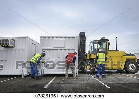 Emergency Response Team workers installing emergency control rooms with fork lift truck View Large Photo Image Stock Image - Emergency Response Team workers installing emergency control rooms with fork lift truck. Fotosearch
