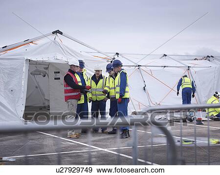 Stock Photo - Emergency Response Team workers training in control centre tent. Fotosearch