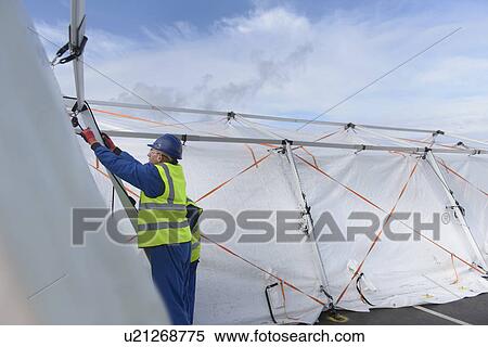 Emergency Response Team workers erecting tent control centre View Large Photo Image Stock Photography - Emergency Response Team workers erecting tent control centre. Fotosearch