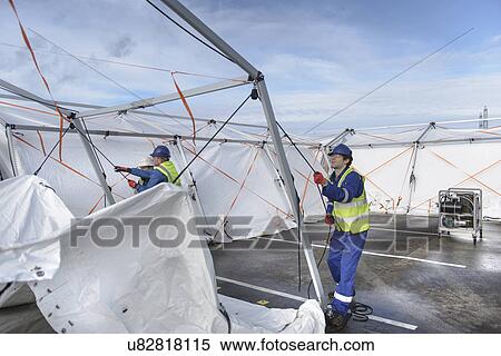 Emergency Response Team workers erecting tent control centre View Large Photo Image Stock Photography - Emergency Response Team workers erecting tent control centre. Fotosearch