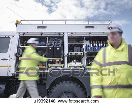 Stock Photo - Emergency Response workers with specialist equipment and rescue truck. Fotosearch