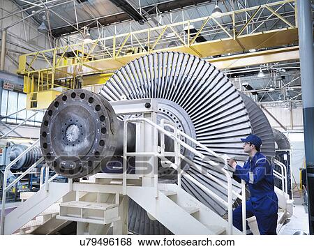 Stock Photo - Engineer in steam turbine repair workshop. Fotosearch