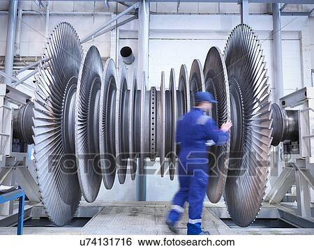 Engineer inspecting steam turbine blades in repair bay of workshop View Large Photo Image Stock Photograph - Engineer inspecting steam turbine blades in repair bay of workshop. Fotosearch