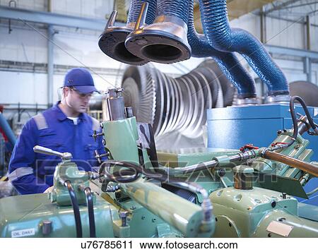 Engineer operating machinery in steam turbine repair workshop View Large Photo Image Stock Image - Engineer operating machinery in steam turbine repair workshop. Fotosearch