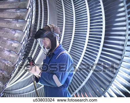 Picture - Engineer repairing steam turbine blade with grinder in workshop. Fotosearch