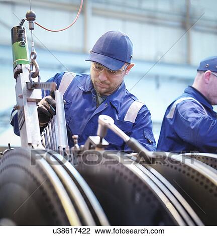 Engineers fitting blades to steam turbine in repair works View Large Photo Image Stock Image - Engineers fitting blades to steam turbine in repair works. Fotosearch