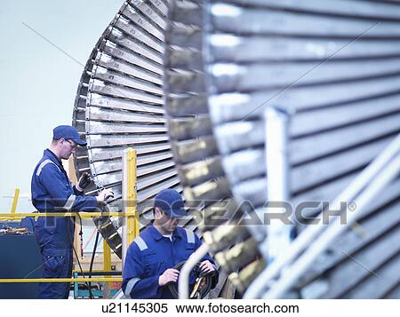 Engineers repairing steam turbine in repair bay in workshop View Large Photo Image Stock Photography - Engineers repairing steam turbine in repair bay in workshop. Fotosearch