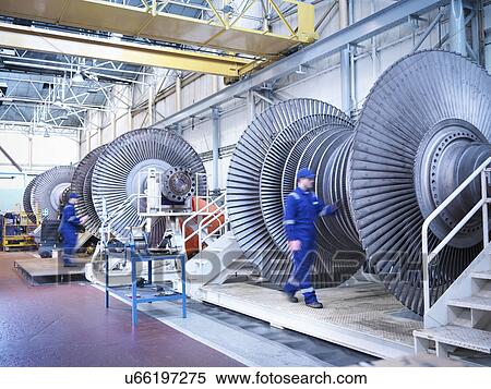 Stock Photography - Engineers with low pressure steam turbines in repair bays in workshop. Fotosearch
