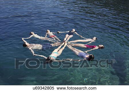 Family group of eight floating on sea in a circle View Large Photo Image Stock Photography - Family group of eight floating on sea in a circle. Fotosearch