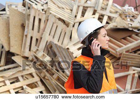 Female dockworker using cellular phone View Large Photo Image Stock Image - Female dockworker using cellular phone. Fotosearch