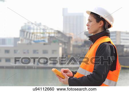 Female dockworker using monitor View Large Photo Image Stock Image - Female dockworker using monitor. Fotosearch