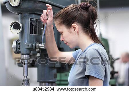 Female engineer using machine in workshop View Large Photo Image Picture - Female engineer using machine in workshop. Fotosearch