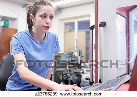 Stock Photo - Female engineer working on computer keyboard. Fotosearch