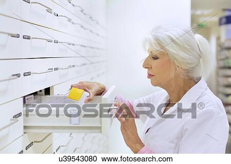 Female pharmacist searching for medicine for prescription View Large Photo Image Stock Image - Female pharmacist searching for medicine for prescription. Fotosearch