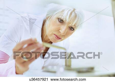 Female pharmacist weighing medicines for prescription View Large Photo Image Stock Image - Female pharmacist weighing medicines for prescription. Fotosearch