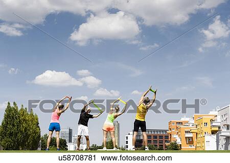 Four people exercising with rubber bands in park View Large Photo Image Stock Image - Four people exercising with rubber bands in park. Fotosearch