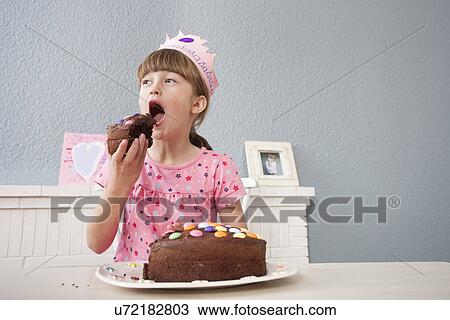 Girl eating her birthday cake View Large Photo Image Stock Image - Girl eating her birthday cake. Fotosearch
