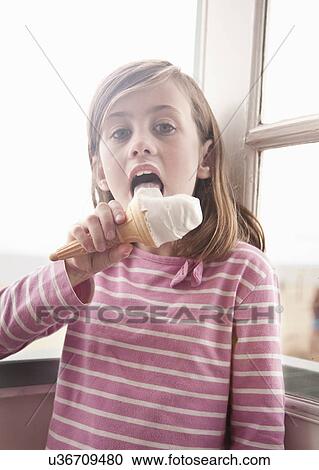 Girl eating ice cream in beach hut porch View Large Photo Image Stock Image - Girl eating ice cream in beach hut porch. Fotosearch