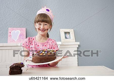 Picture - Girl showing off her birthday cake. Fotosearch