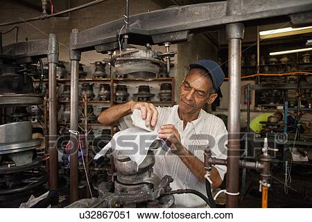 Hat maker measuring and chalking fabric in workshop View Large Photo Image Stock Image - Hat maker measuring and chalking fabric in workshop. Fotosearch