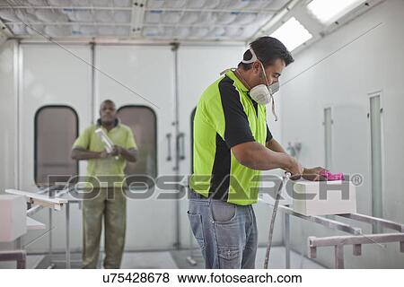 Man spraying box in carpenters workshop View Large Photo Image Stock Photo - Man spraying box in carpenters workshop. Fotosearch
