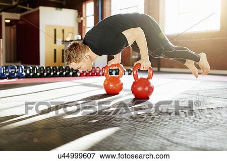 Man strength training with kettle bells View Large Photo Image Stock Photo - Man strength training with kettle bells. Fotosearch