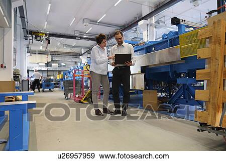 Manager and work colleague checking information on laptop View Large Photo Image Stock Photo - Manager and work colleague checking information on laptop. Fotosearch