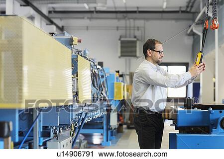 Manager monitoring information on industrial machinery View Large Photo Image Stock Image - Manager monitoring information on industrial machinery. Fotosearch