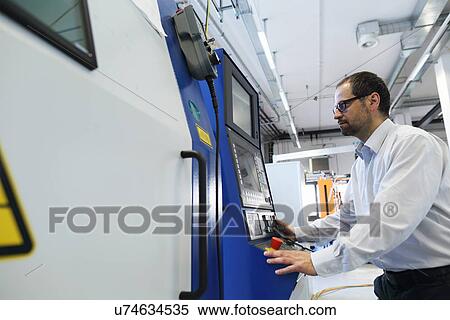 Stock Photography - Manager monitoring information on computer system. Fotosearch