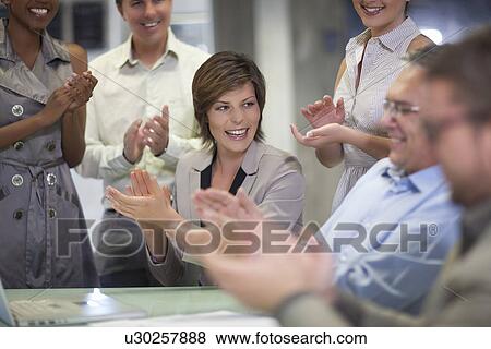 Mature businessman and colleagues celebrating in office View Large Photo Image Stock Photo - Mature businessman and colleagues celebrating in office. Fotosearch