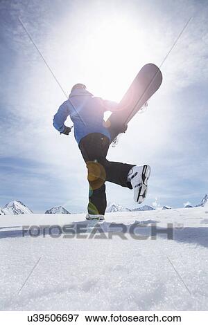 Mature man carrying his snowboard uphill, Obergurgl, Austria View Large Photo Image Stock Photo - Mature man carrying his snowboard uphill, Obergurgl, Austria. Fotosearch