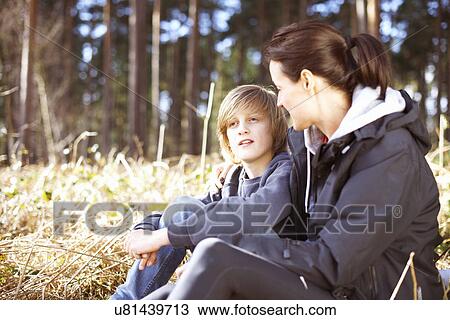 Mature woman taking a break with her son in a forest View Large Photo Image Stock Image - Mature woman taking a break with her son in a forest. Fotosearch
