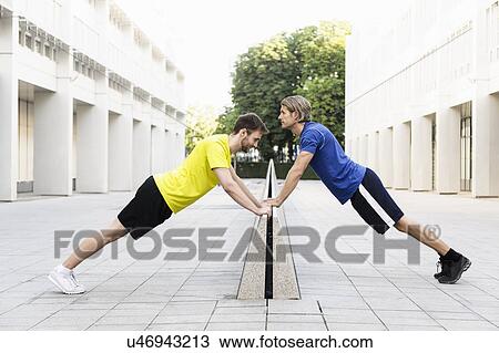 Men stretching on divider View Large Photo Image Stock Image - Men stretching on divider. Fotosearch