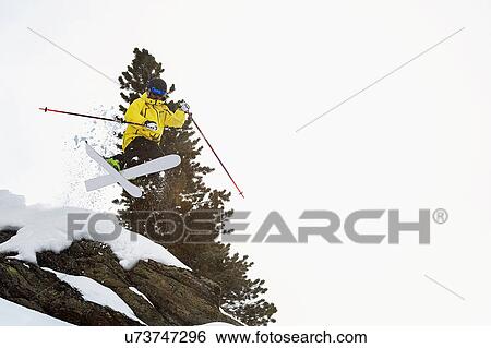 Mid adult male skier jumping mid air, Obergurgl, Austria View Large Photo Image Stock Photograph - Mid adult male skier jumping mid air, Obergurgl, Austria. Fotosearch