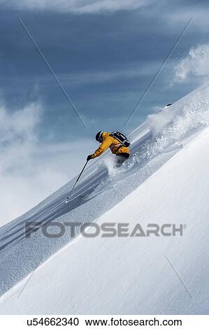 Stock Image - Mid adult male skier speeding downhill, Obergurgl, Austria. Fotosearch