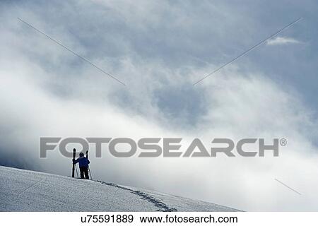 Stock Photo - Mid adult male skier standing on hill, Obergurgl, Austria. Fotosearch