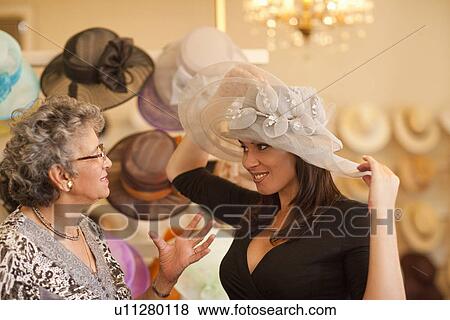 Milliner and customer in hat shop View Large Photo Image Stock Photo - Milliner and customer in hat shop. Fotosearch