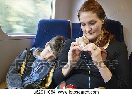 Picture - Mother and son sitting on train. Fotosearch