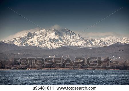 Stock Image - Mount Rosa beyond Lake Maggiore, Arona, Italy. Fotosearch