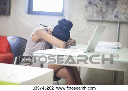 Stock Image - Office worker stressed and upset in office. Fotosearch