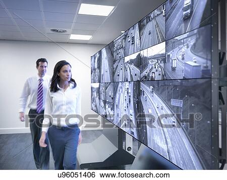 Operators walking by traffic control screens View Large Photo Image Stock Photograph - Operators walking by traffic control screens. Fotosearch