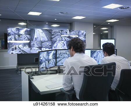 Stock Photo - Operators with screens in traffic control room. Fotosearch